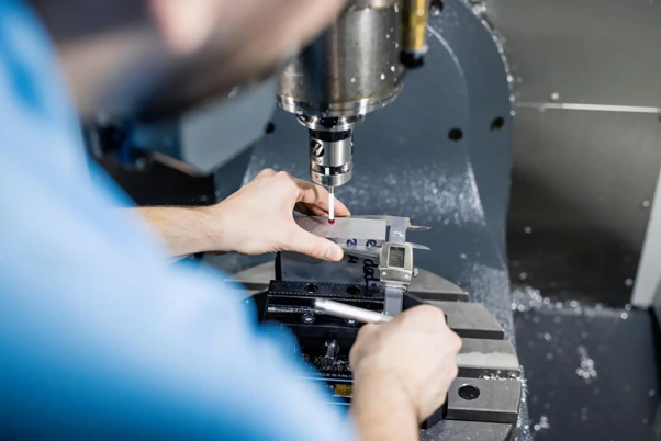 Engineer performing precision Green Machining on a ceramic component using a CNC machine.