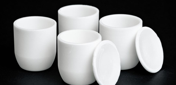 White zirconia crucibles with matching lids designed for high-temperature laboratory and industrial applications.