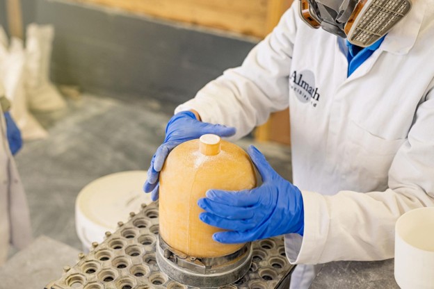 Technician handling pressed ceramics during the cold isostatic pressing process to manufacture high-performance ceramic components.