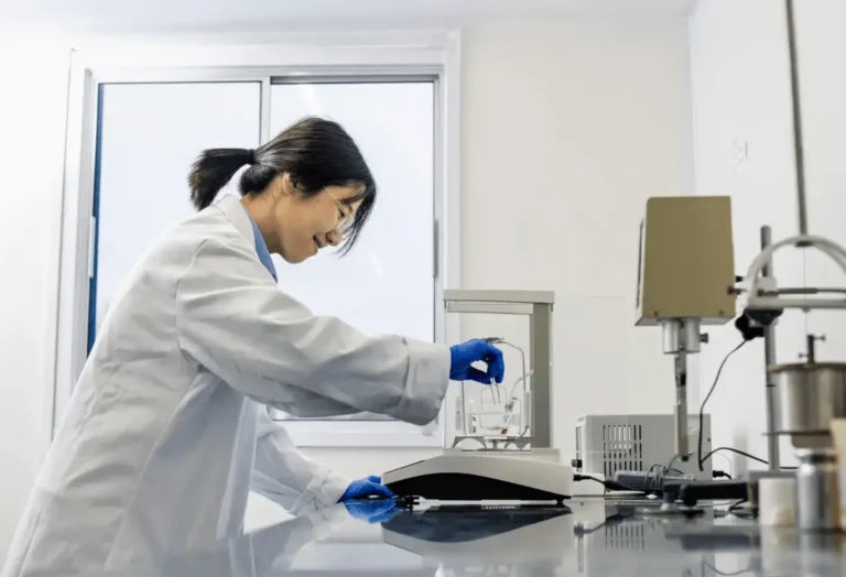 Laboratory technician using precision equipment to test materials in a laboratory, supporting research into ceramic crucibles and components.